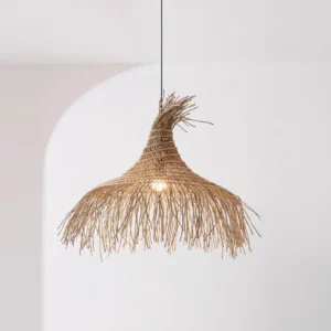 Bohemian rattan pendant light with cascading fringe detailing, creating organic shadow patterns on wall