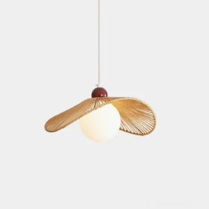 Wabi-sabi rattan woven pendant lamp with natural brown hat-shaped shade, front view with opal white bulb on studio backdrop
