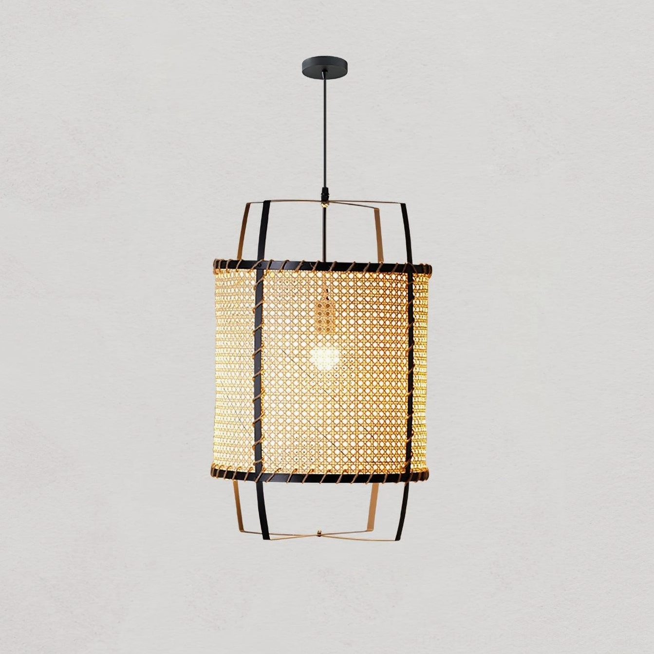 Organic rattan cylinder pendant light installation angle and height perspective