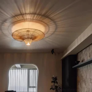 Rattan pendant chandelier installed indoors casting warm soft radial lighting through woven shade in living room setting