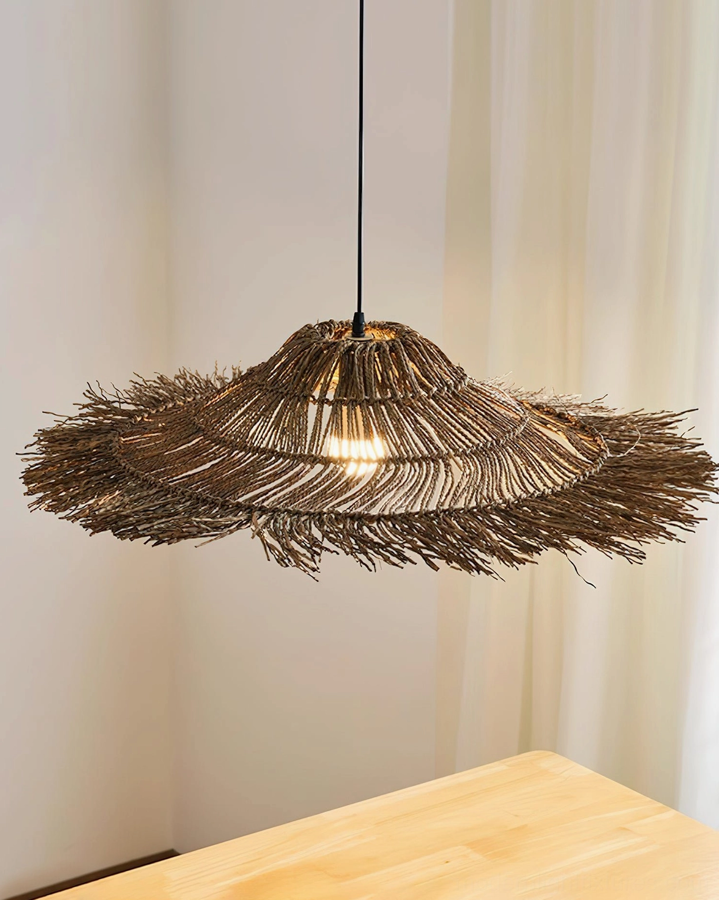 Size comparison of natural rattan pendant lights in different diameters arranged together, showing scale variations