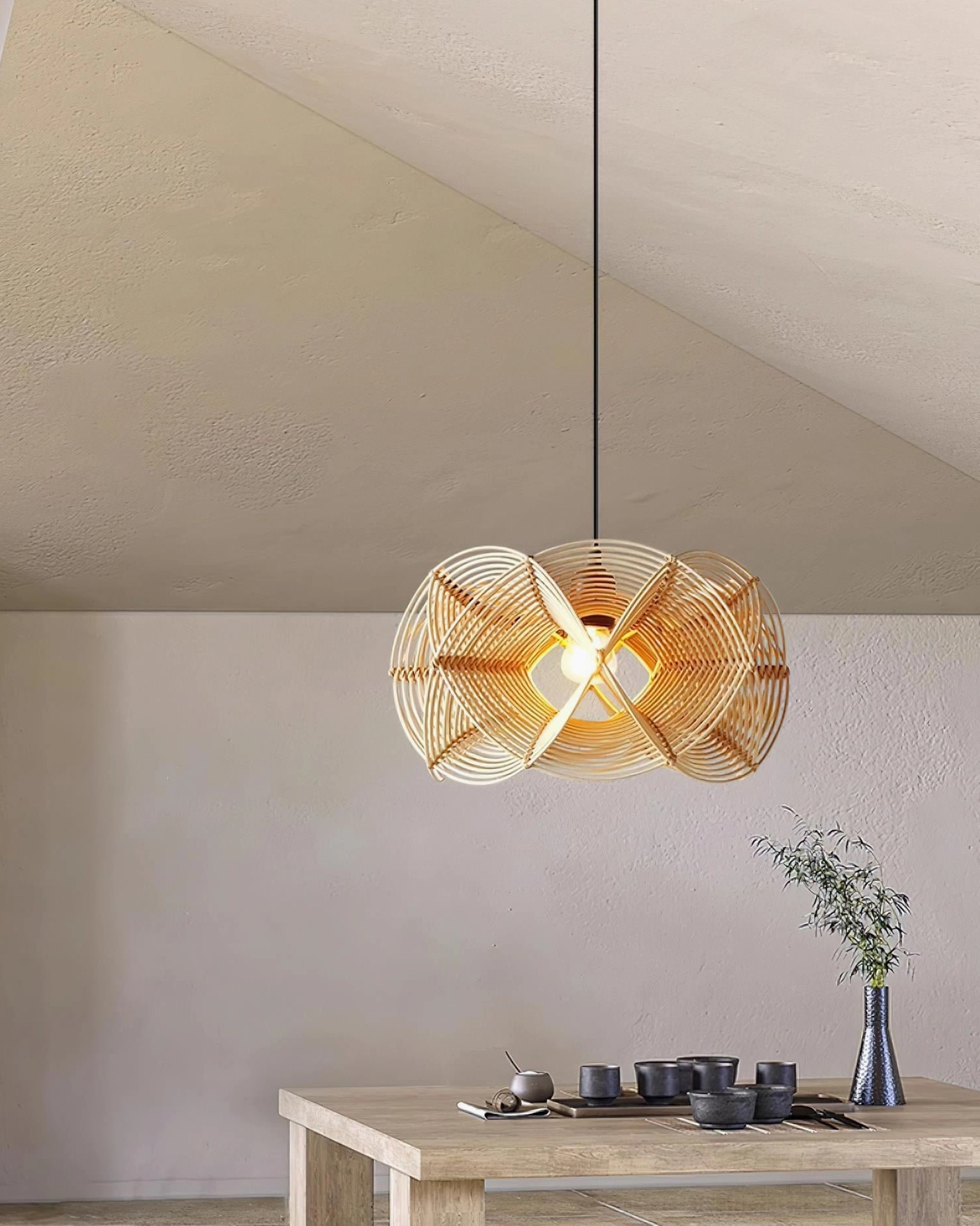 Overhead rattan pendant light fixture in small studio space with side table accent styling