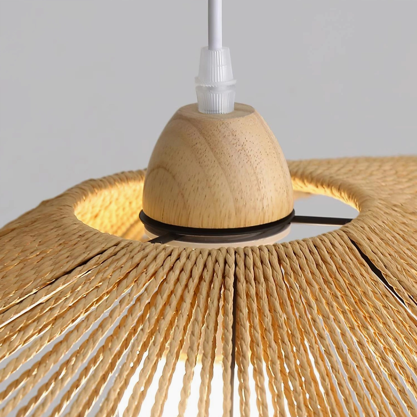 Soft diffused lighting from handwoven rattan pendant lamp creating warm cozy ambiance