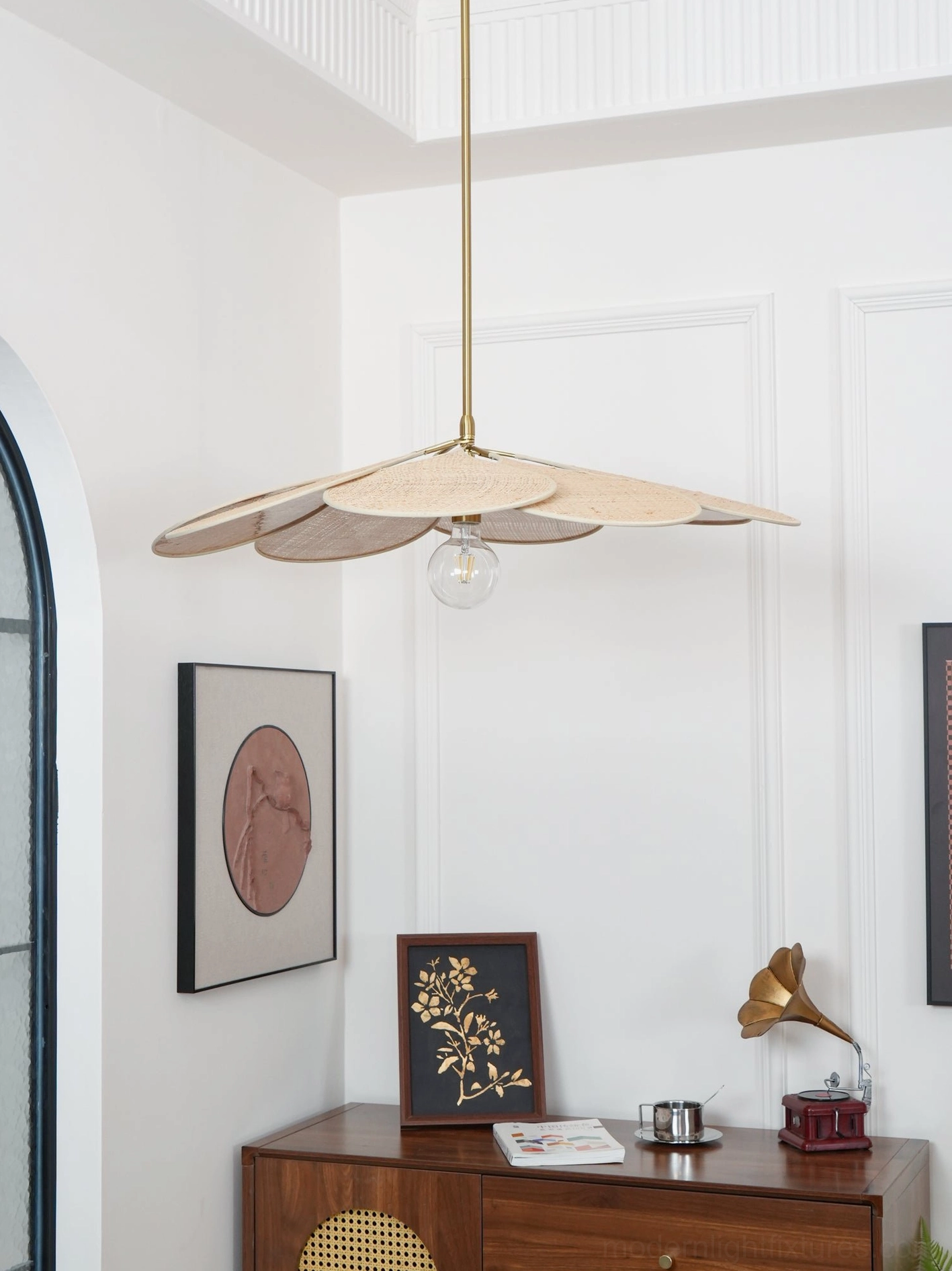 Rattan petal pendant light in mid-century modern bohemian living room with vintage furnishings