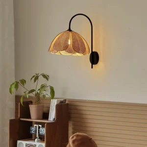 Black curved metal arm rattan wall lamp installed in retro wooden home corner, warm glowing light diffusion