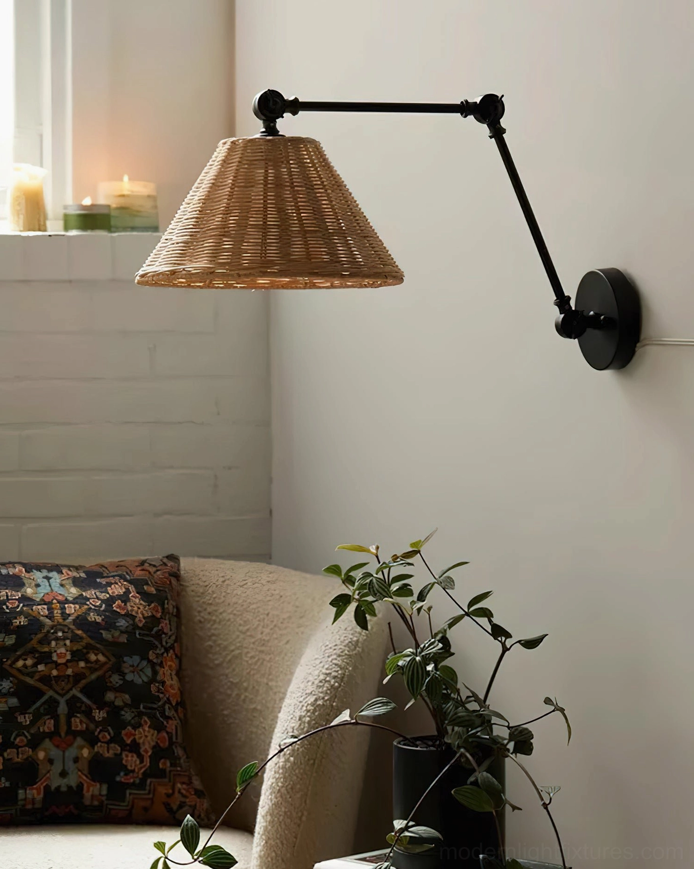 Rattan shade swing arm sconce in cozy living room with candles and decorative elements