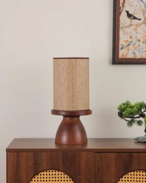 Contemporary bedroom table lamp with woven rattan shade on walnut base, styled in modern home interior