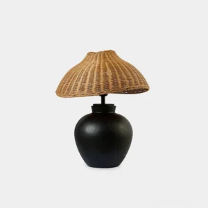 Rattan table lamp with matte black wooden base and hand-woven natural rattan shade, frontal product view on white background