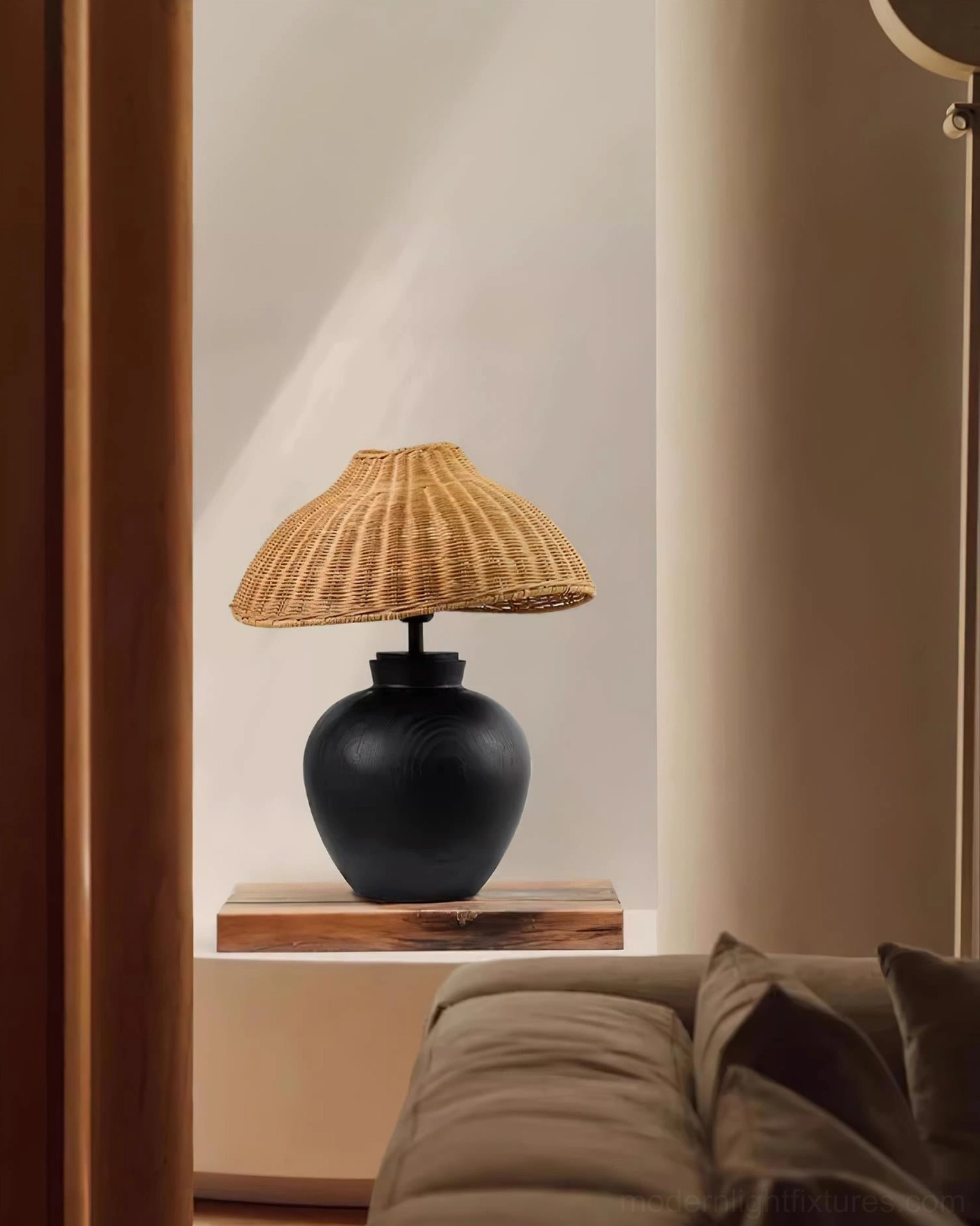 Rattan table lamp accent lighting on living room floating shelf, contemporary interior design example