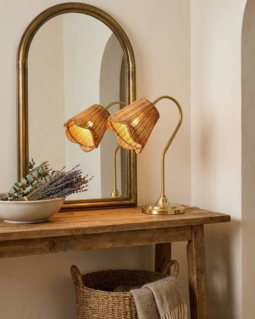 Gold-tone metal gooseneck arm and base of rattan table lamp showing warm brass-like finish