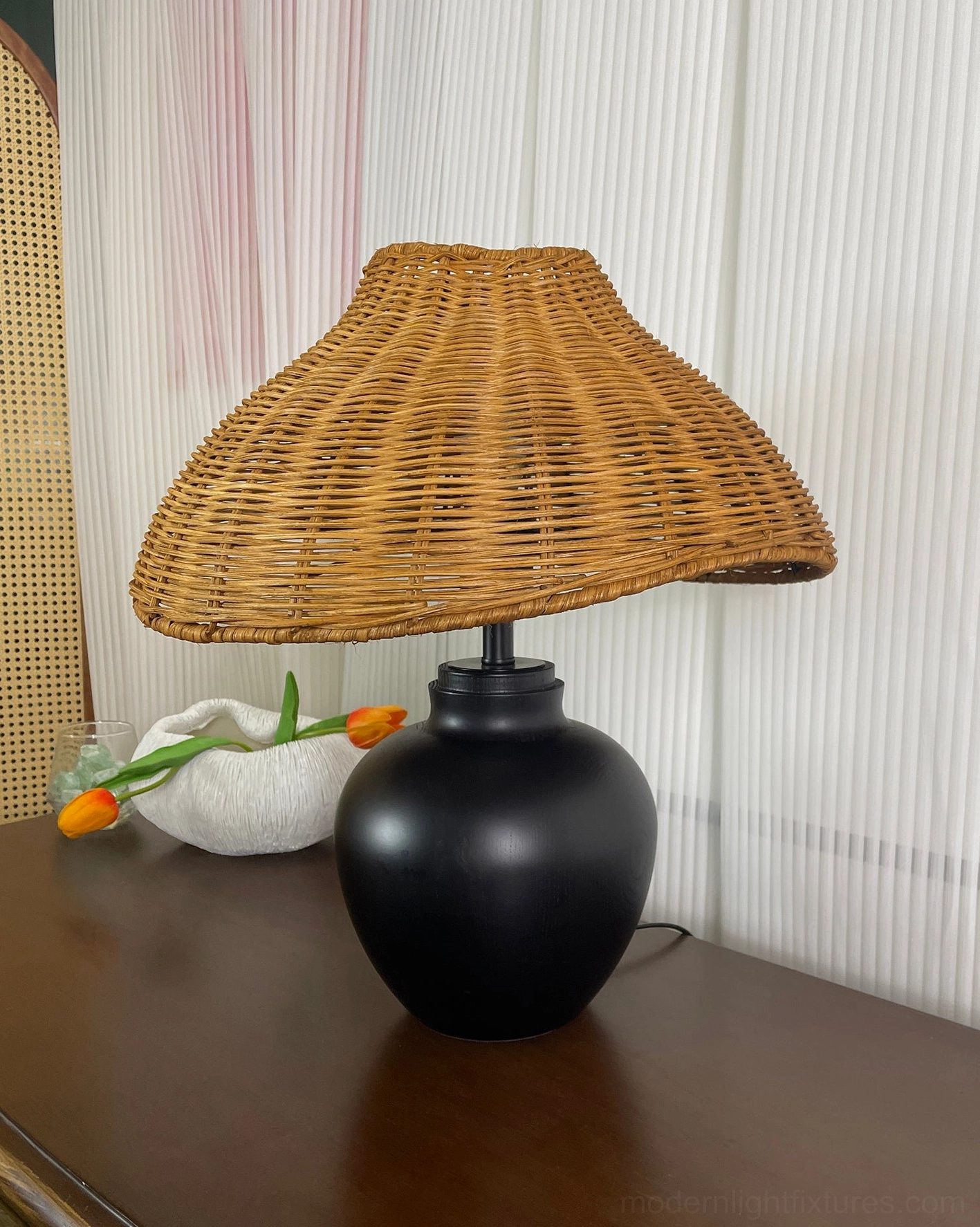Rattan table lamp with natural rattan weave shade and matte black wooden base, Japanese-inspired design