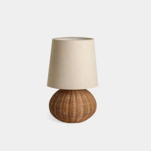 Handwoven rattan table lamp with spherical base and beige linen shade, front view on white background showing bohemian lighting design