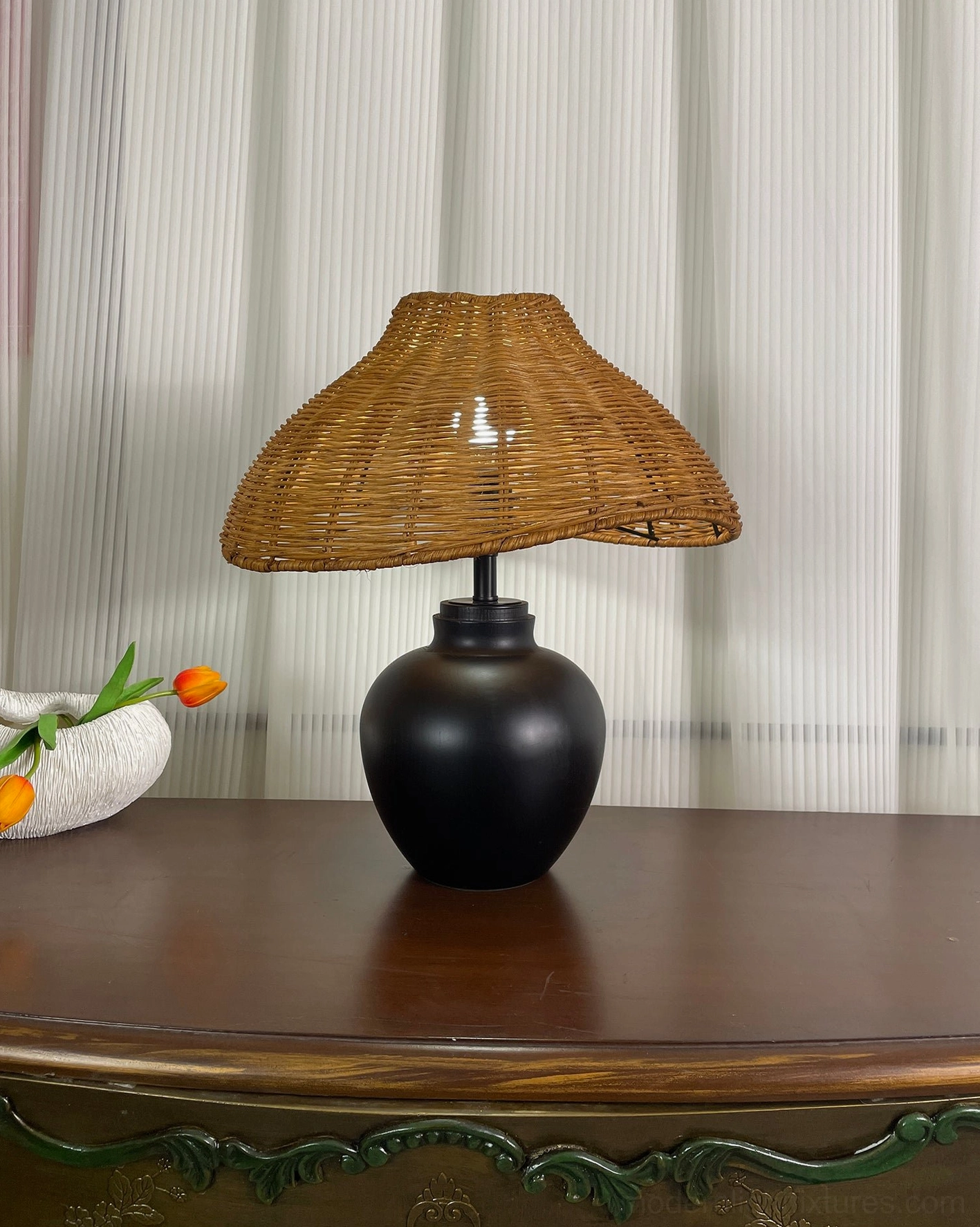 Rattan table lamp in transitional interior design setting, bridging traditional and contemporary aesthetics