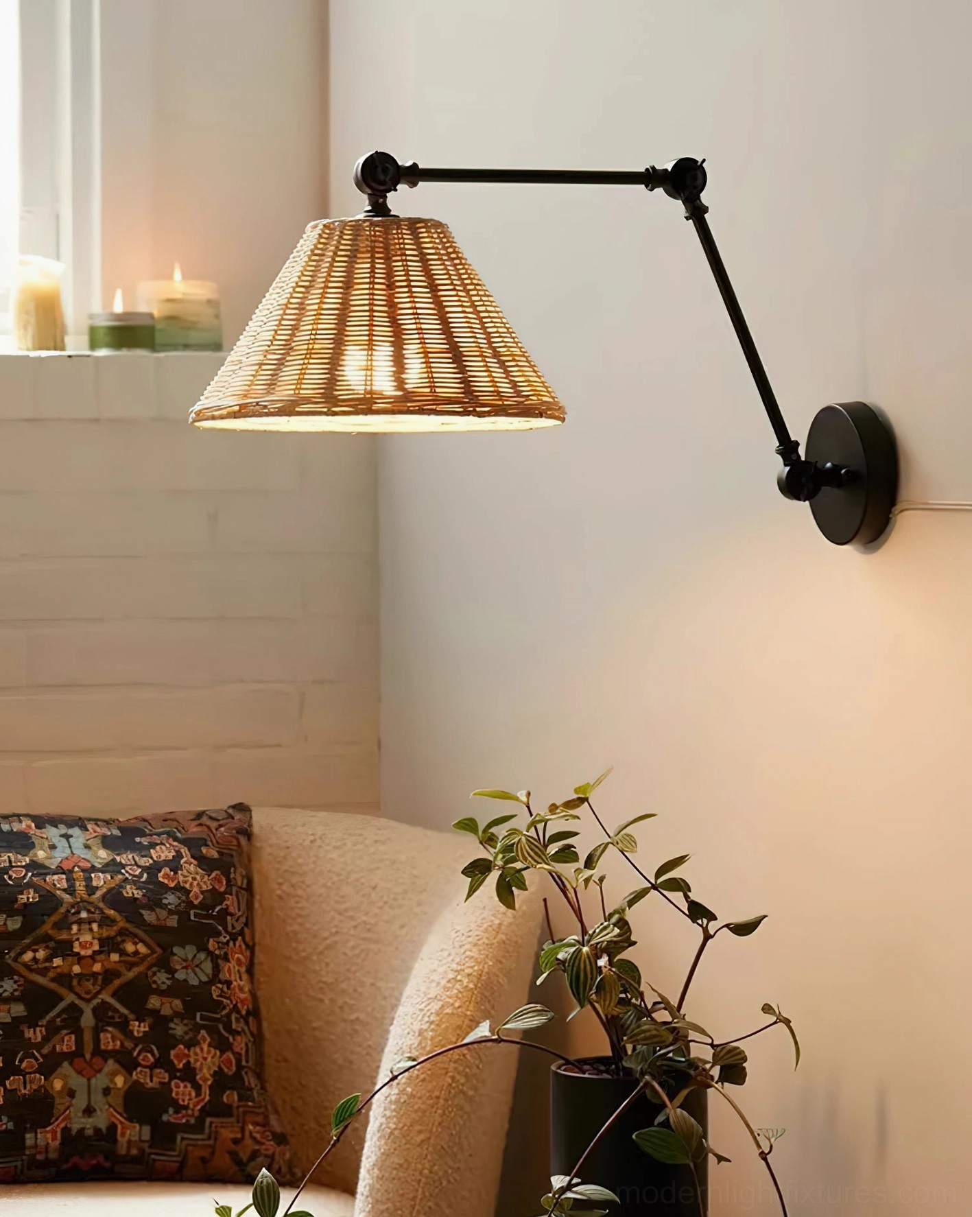 Lit rattan swing arm wall lamp in boho living room with warm ambient glow and natural light
