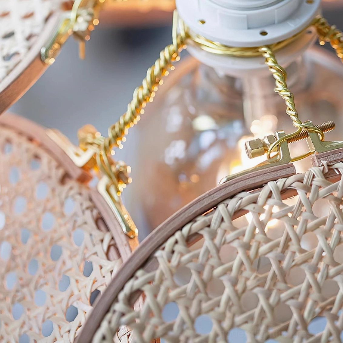 Close-up macro detail of rattan weaving texture and brass gold metal fixtures with twisted suspension chain