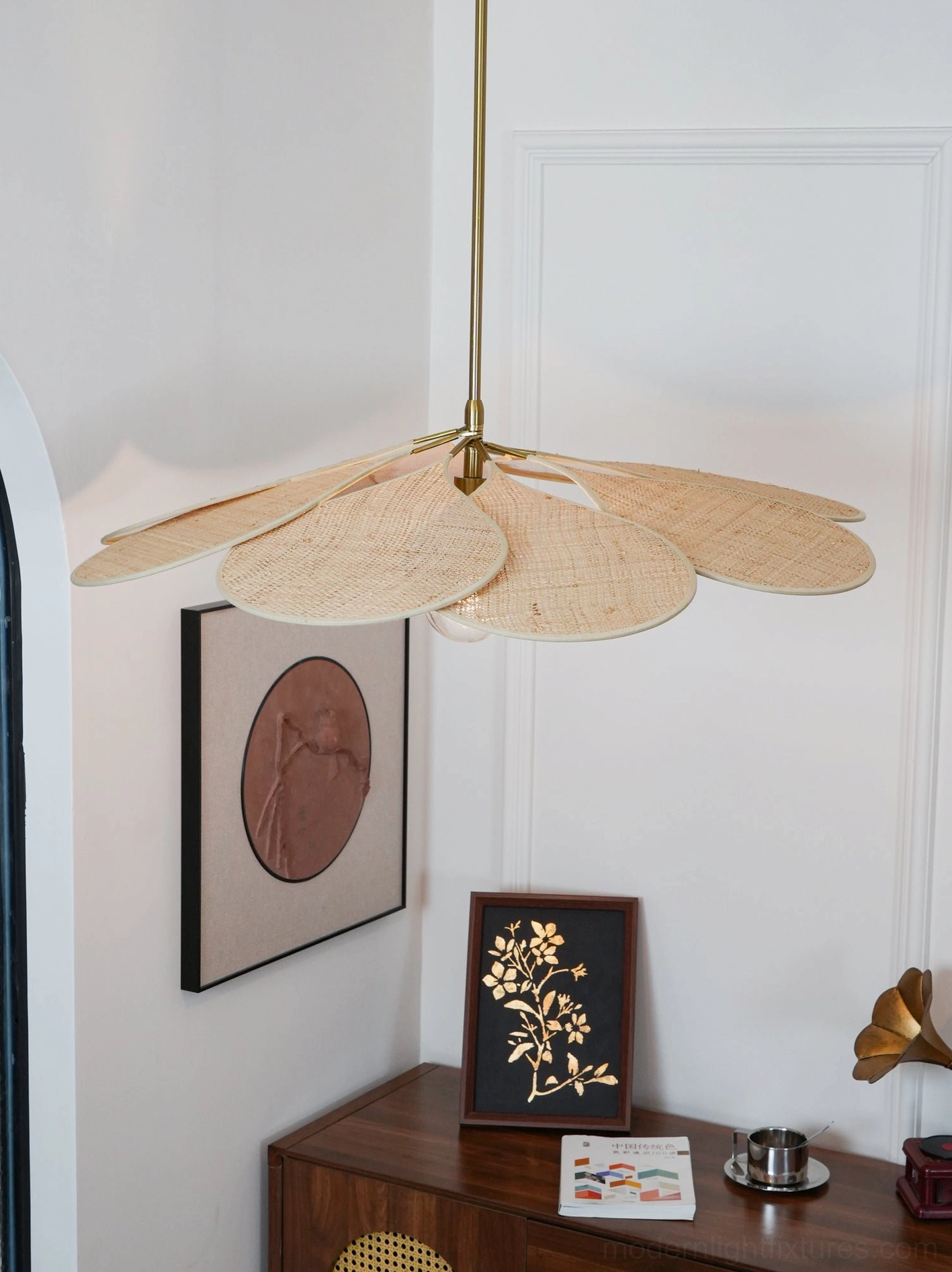 Rattan woven pendant light above dining table creating elegant warm focal point for gatherings