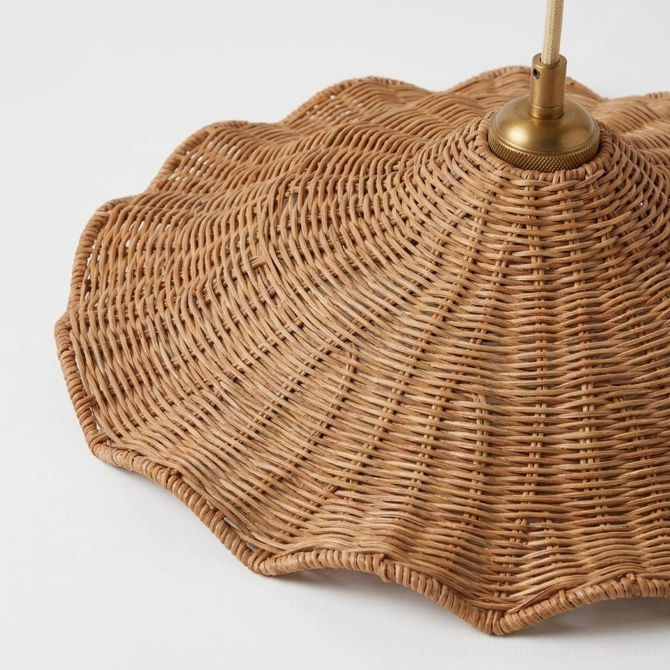 Close-up overhead view of Ravela rattan pendant showing detailed handwoven texture, scalloped wave edge rim, and brass fixture top