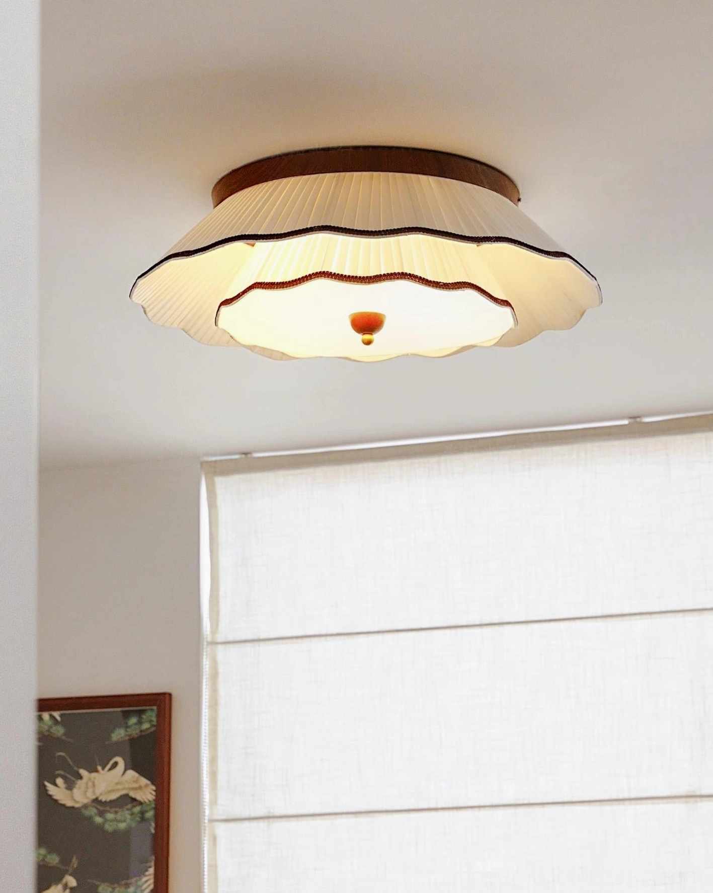 Ravelle vintage ceiling light fixture illuminated in living room with warm glow and layered fabric shade