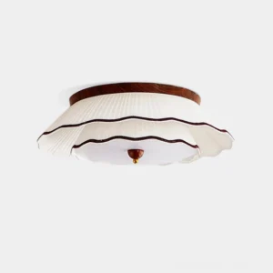 Ravelle pleated fabric ceiling light fixture with white ruffled shade and walnut wood base in studio view
