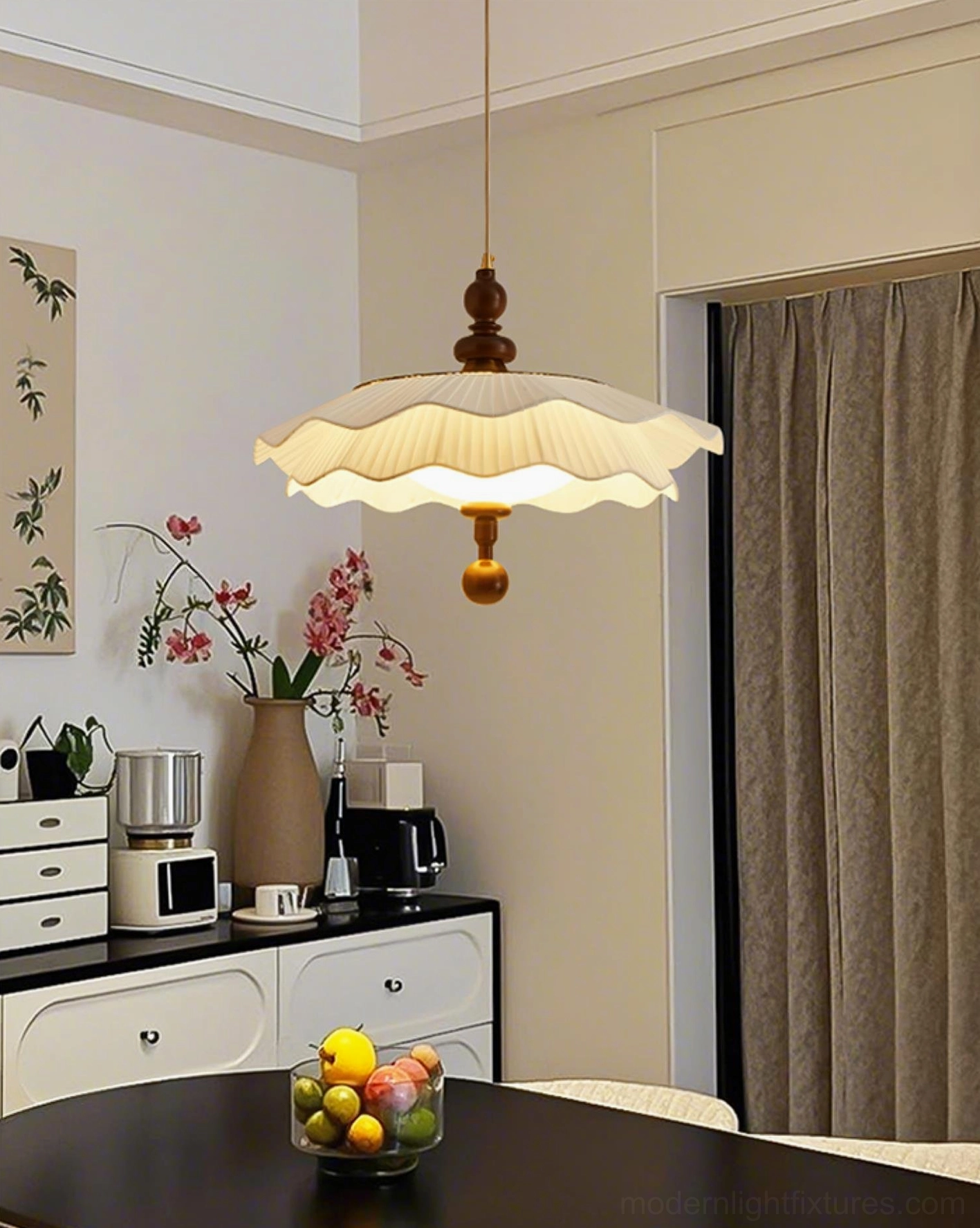 Ravina pleated pendant light installed above dark wooden dining table in residential dining room