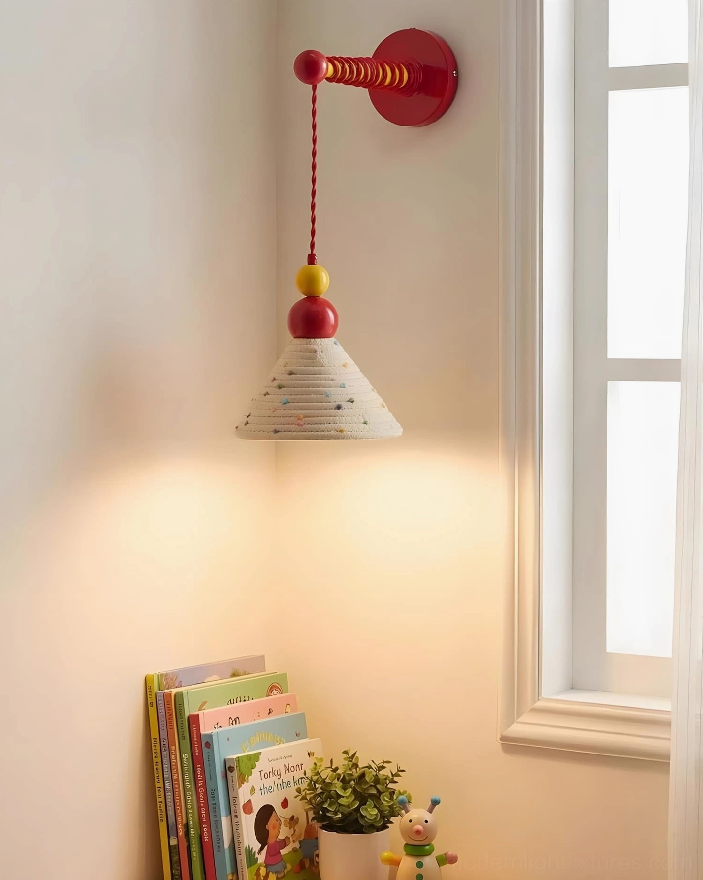 Reading nook wall sconce fixture mounted near window with stacked books and decorative plant accessories