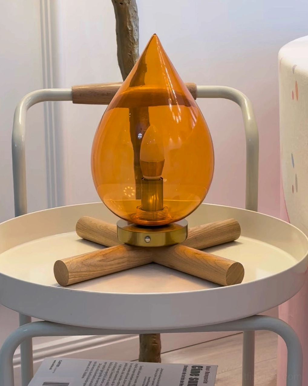 Cordless rechargeable table lamp with natural wood base on serving trolley in contemporary home
