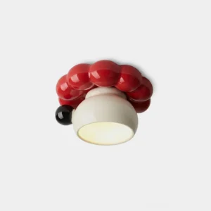 Red berry bubble ceramic flush mount ceiling light, close-up overhead view showing glossy red spheres and cream ceramic bowl with black accent bead