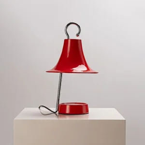 Contemporary candle warmer lamp featuring red bell shade with matching red base and polished chrome accents, three-quarter perspective