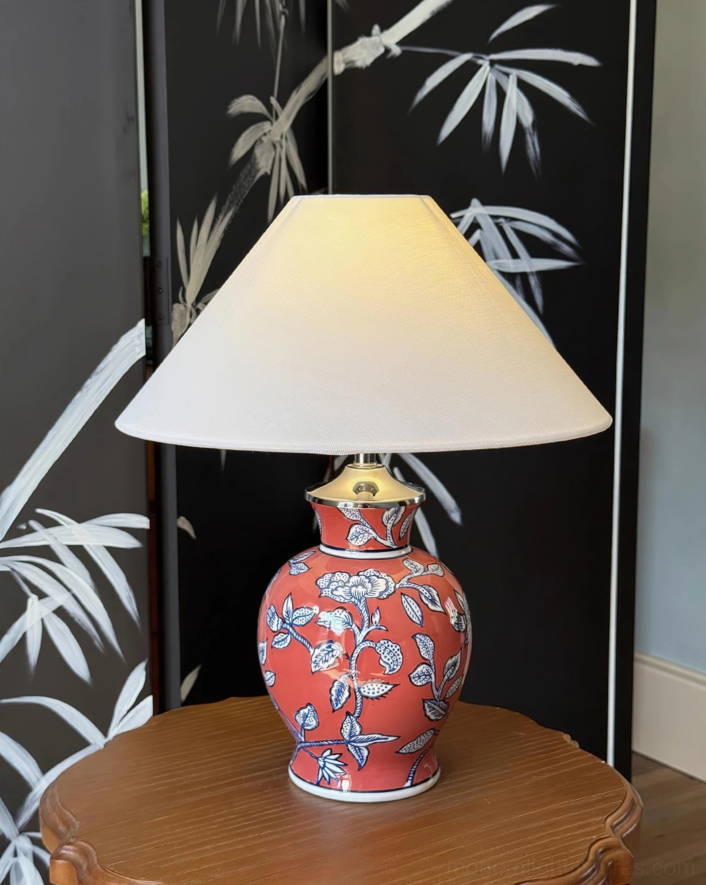 Red ceramic table lamp with white flower pattern and fabric shade, oriental style home interior design setting