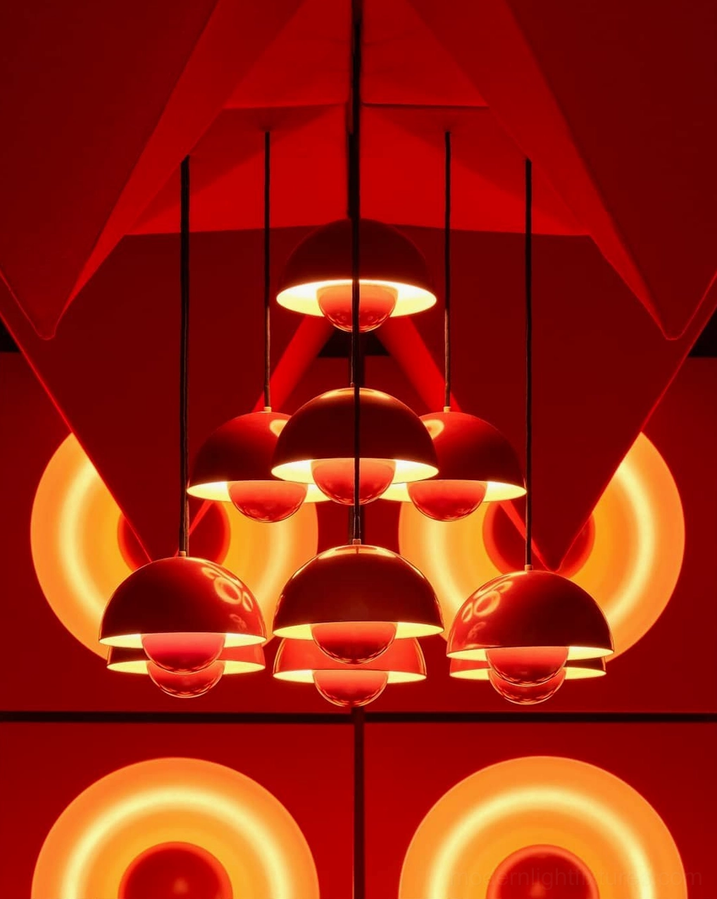 Red hemispherical pendant chandelier close-up overhead view showcasing mood lighting with warm glowing backlit halo design effect