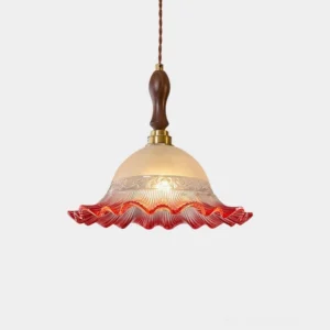 Red frosted glass hand-blown pendant light with walnut wood and brass details, studio close-up view