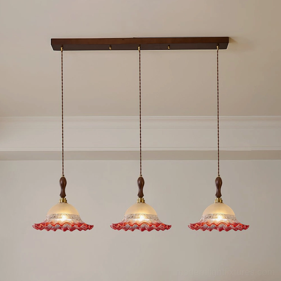 Red frosted glass pendant light with ruffled edge and walnut wood spindle component