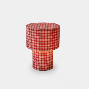Red gingham latticefield cylindrical table lamp with checkered fabric design front view studio shot