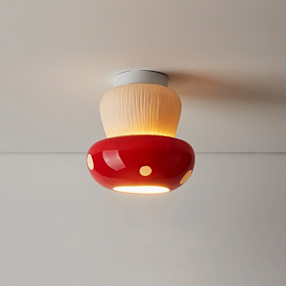 Red ceramic mushroom ceiling lamp with illuminated polka dots casting warm ambient light indoors