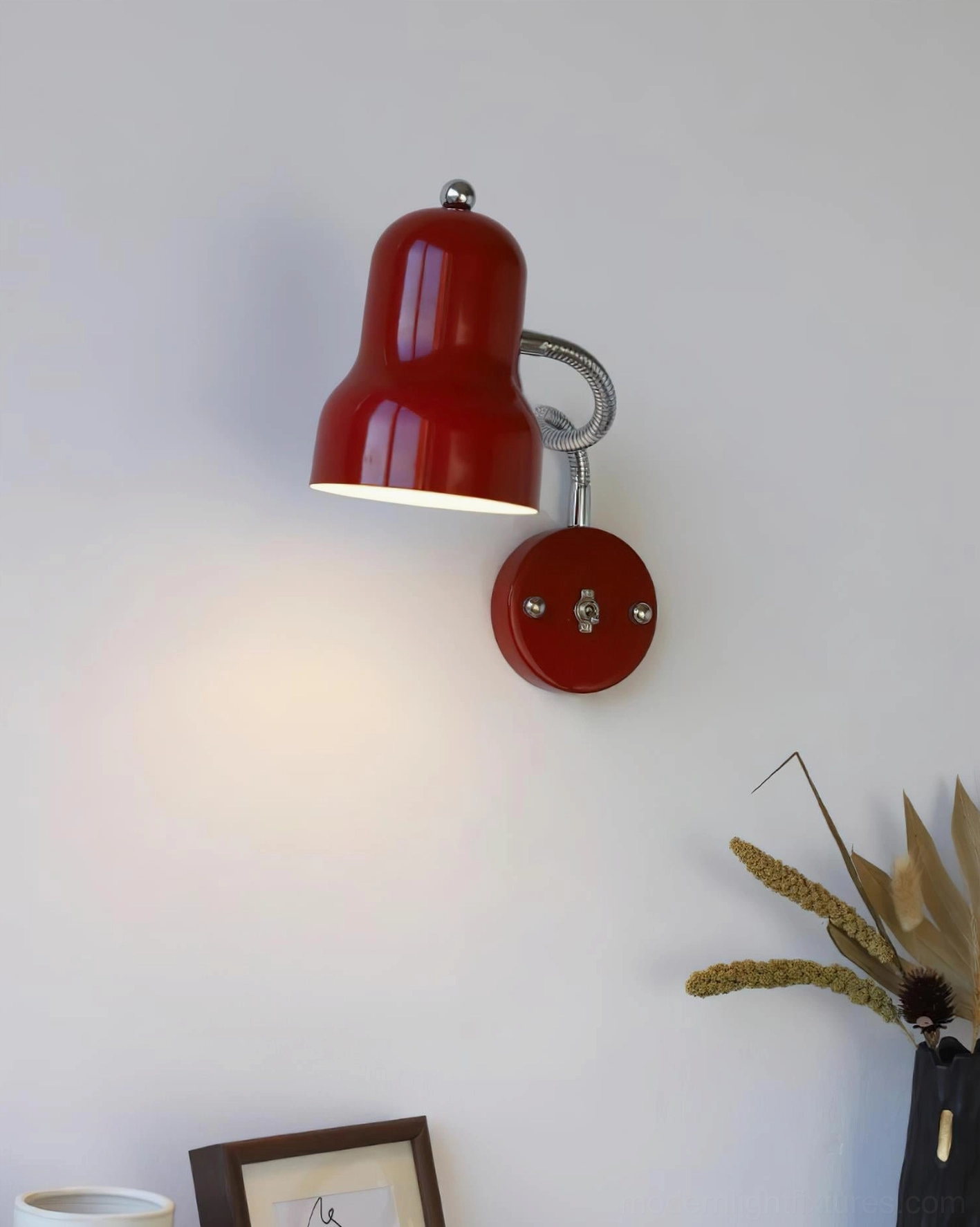 Pair of red industrial wall sconces styled in modern bedroom with symmetrical wall mount display