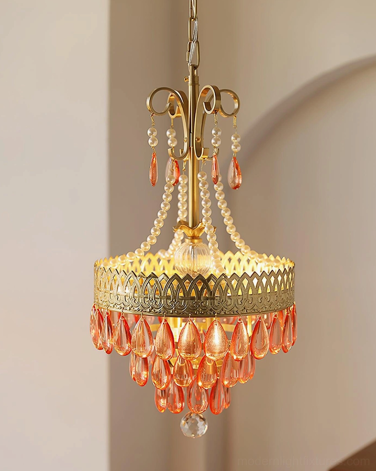 Red ruby crystal chandelier close-up detail indoor arched corridor warm glowing brass frame