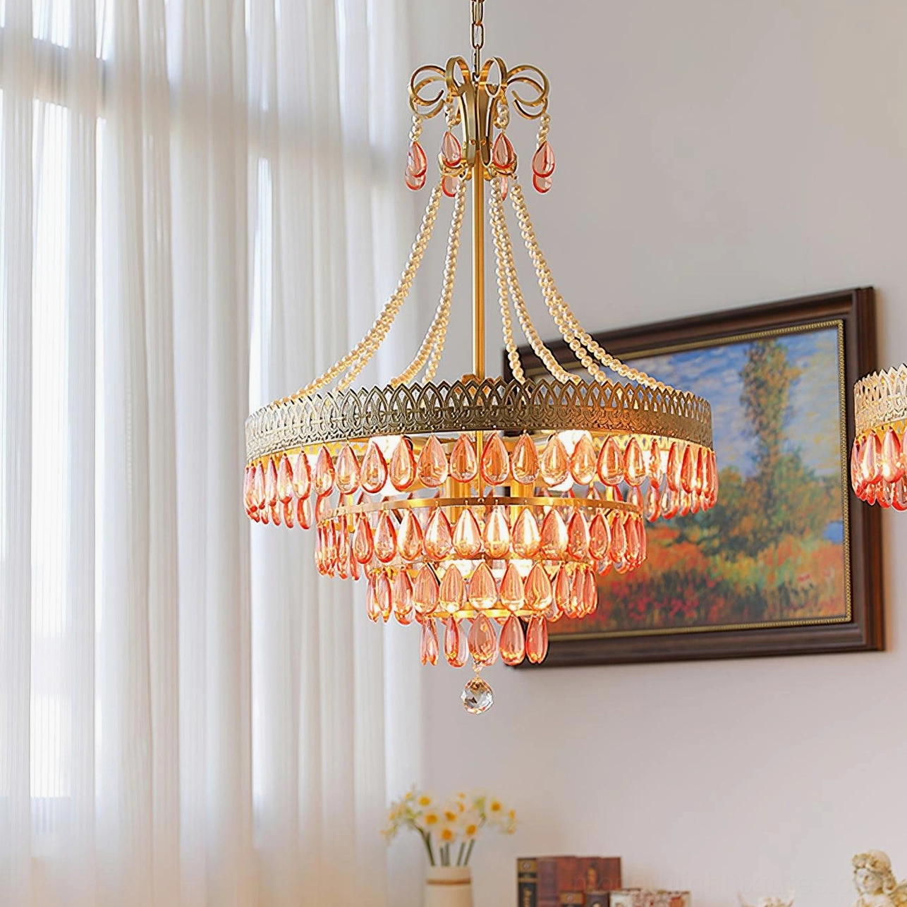Red ruby crystal chandelier hanging in American style living room with sheer curtains warm lighting