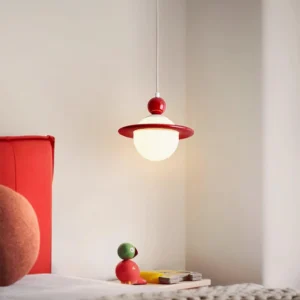Red adjustable pendant lamp hanging above bedroom with modern minimalist Nordic decor and red bedding