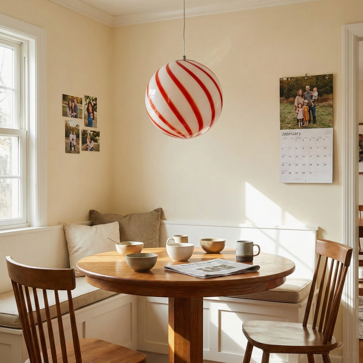 Red and white spiral stripe glass globe pendant light, side profile view displaying the geometric sphere shape and stripe pattern