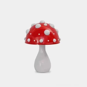 Red spotted mushroom table lamp with glowing LED cap on white background, front view showing cartoon cute design