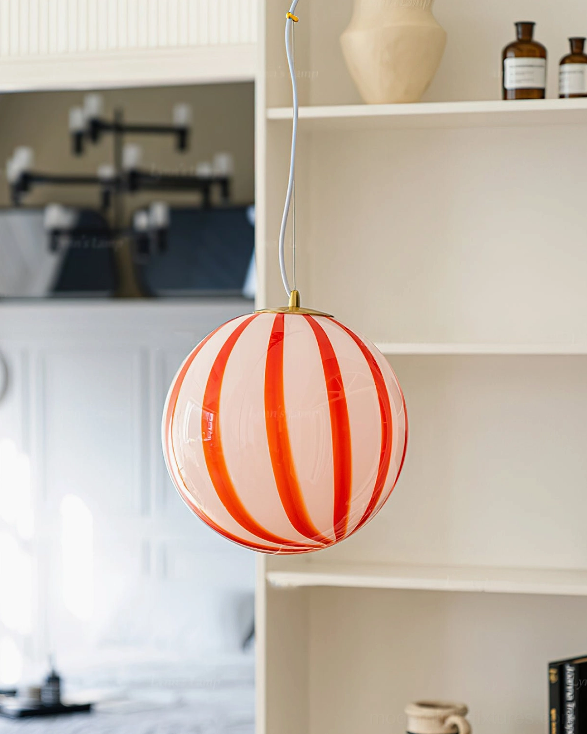 Red striped spherical pendant light three-quarter angle view showing stripe pattern