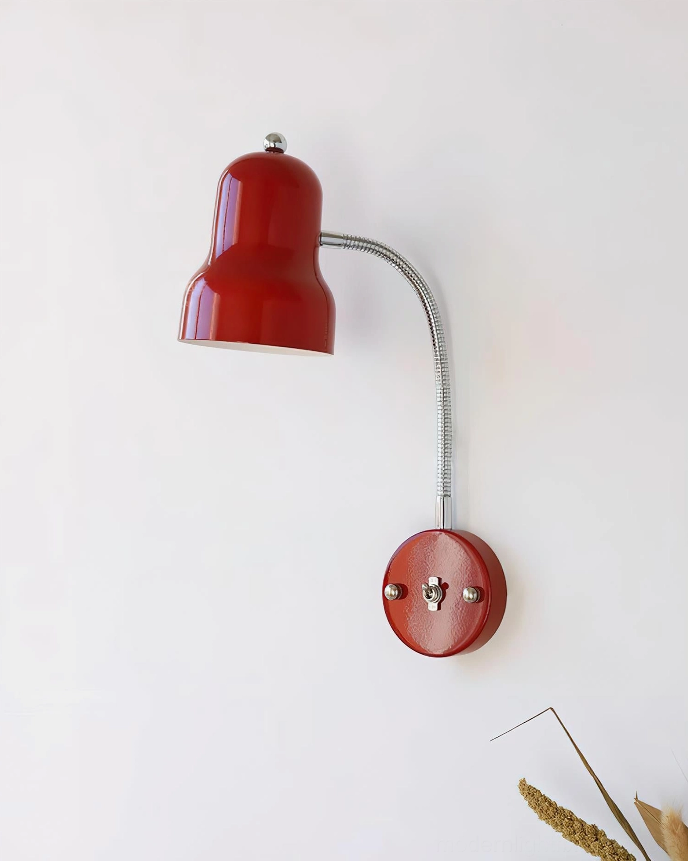 Close-up detail of red enamel finish and chrome finial on industrial gooseneck wall sconce