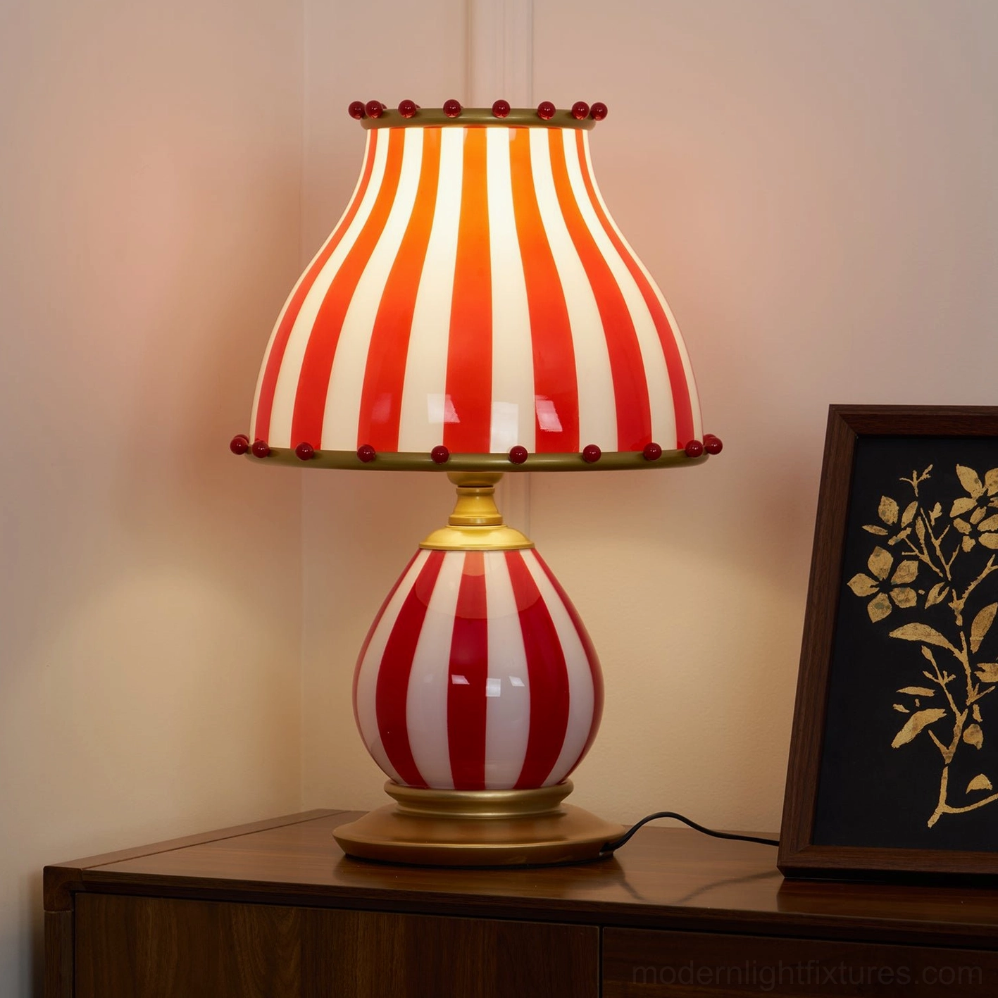 Red and white pom-pom table lamp creating warm ambient light home decor