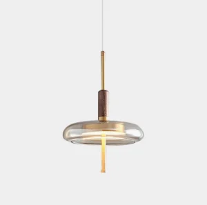 Redondo amber glass pendant lamp close-up front view, showing polished brass hardware and hand-blown amber shade in modern luxury style
