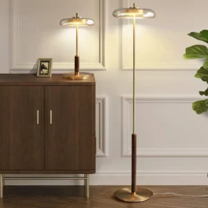 Pair of matching Redondo brass floor and table lamps in luxury wainscoted living room with mid-century modern interior design