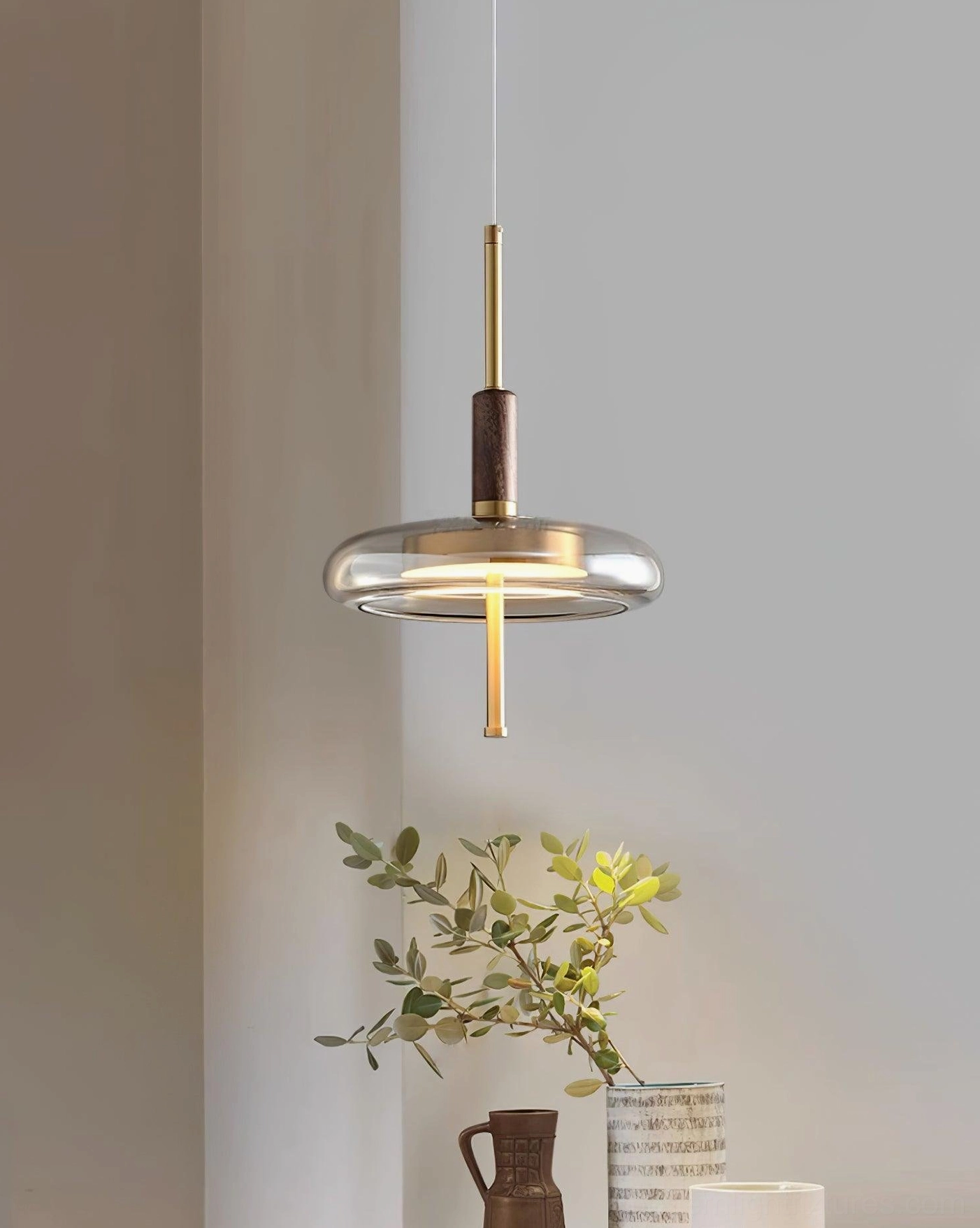 Redondo contemporary pendant lamp side perspective in minimalist corner with greenery, warm modern home styling