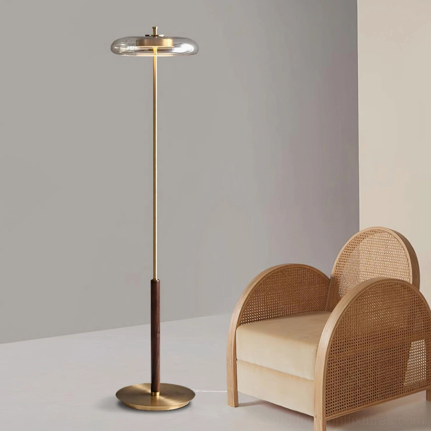 Redondo floor lamp with clear glass disc shade in minimalist luxury furniture display space showcasing warm brass and walnut materials