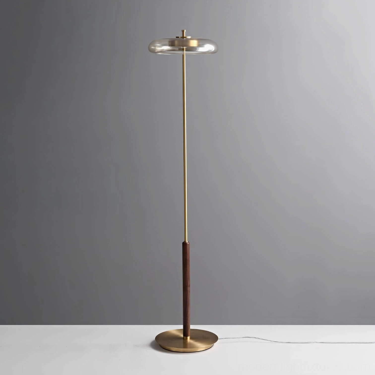 Close-up of Redondo floor lamp disc shade glass and brass frame construction showcasing premium materials and craftsmanship