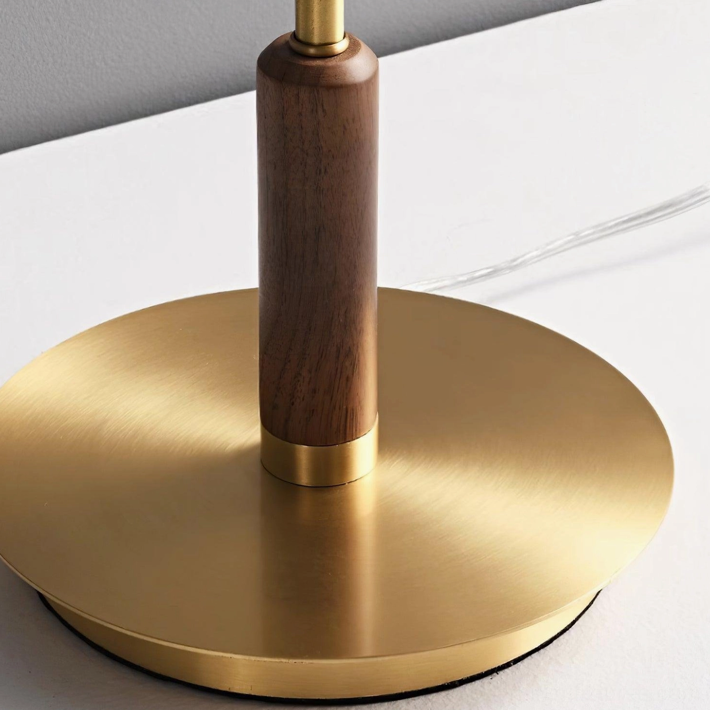Redondo floor lamp sculptural form with 50000 hour LED lifespan integrated into brass and walnut construction