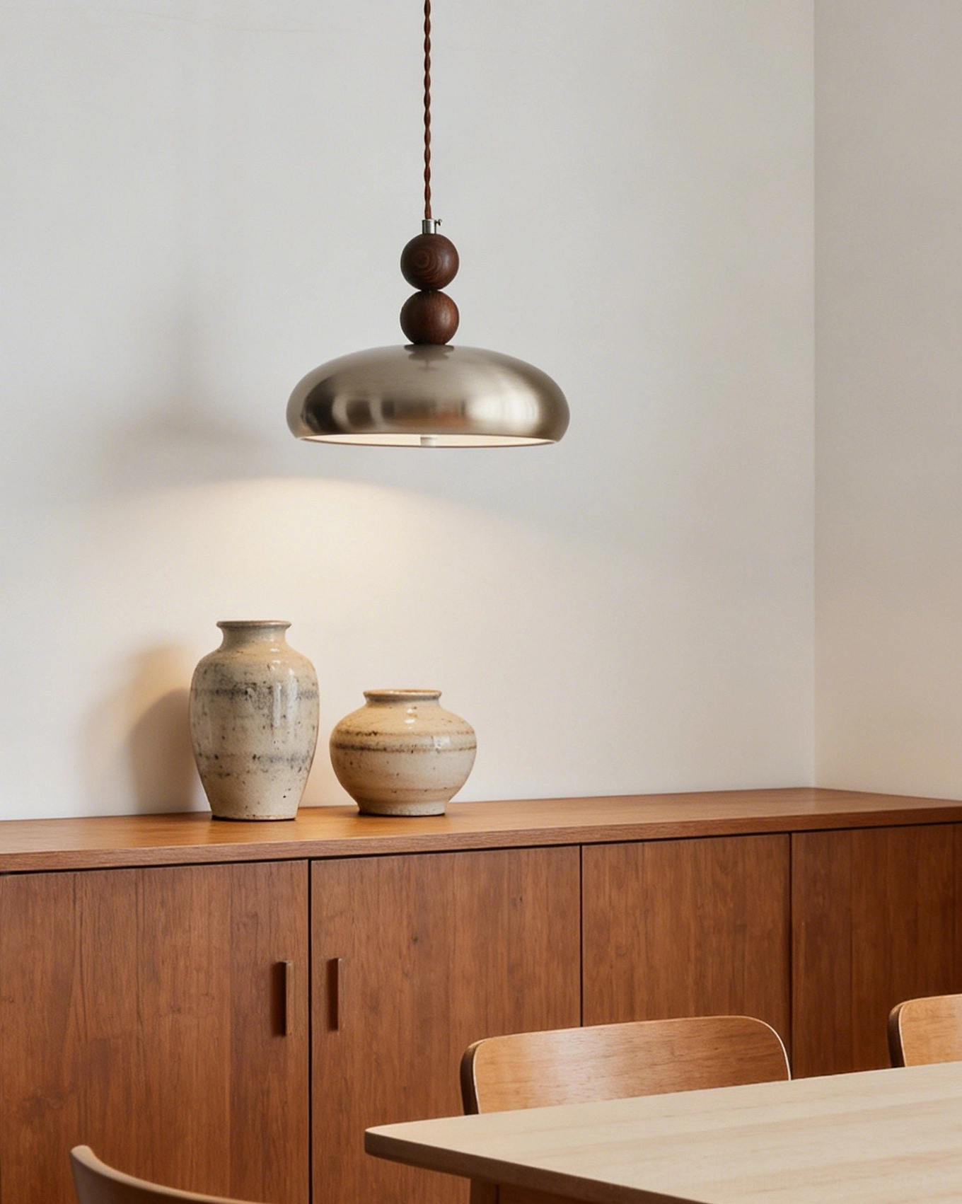 Rellin wooden bead pendant light displayed on dining sideboard with japandi retro style wooden furniture and ceramic vases